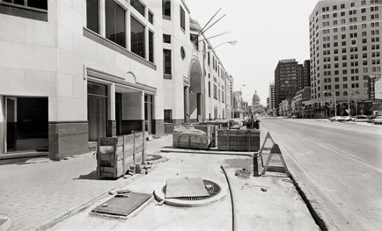 Northwest corner, Congress Avenue and Sixth Street, looking north. One American Center, nearing completion. (1984)